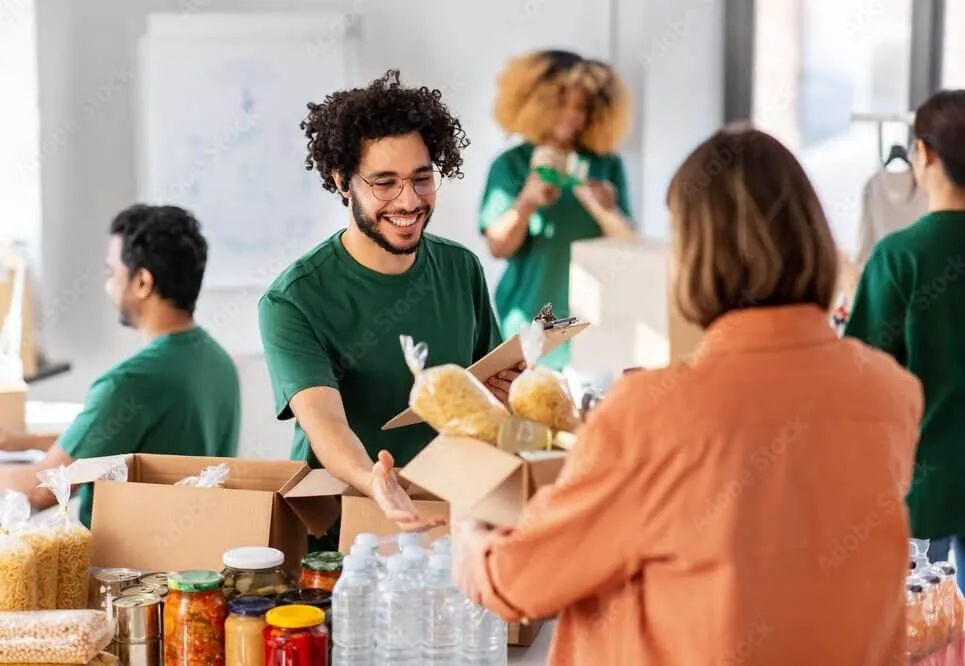 Mains de bénévoles réunies au centre d’un cercle